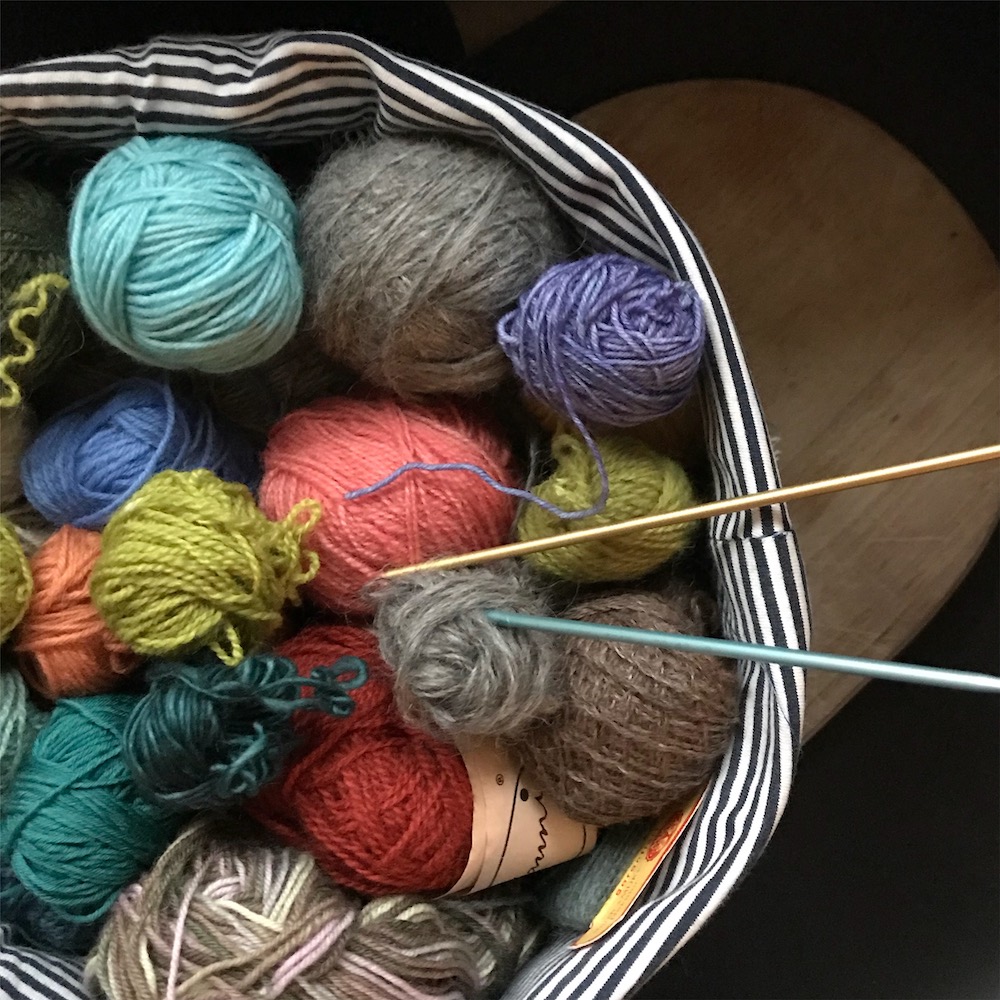 a basket full of scrap yarns in many colours